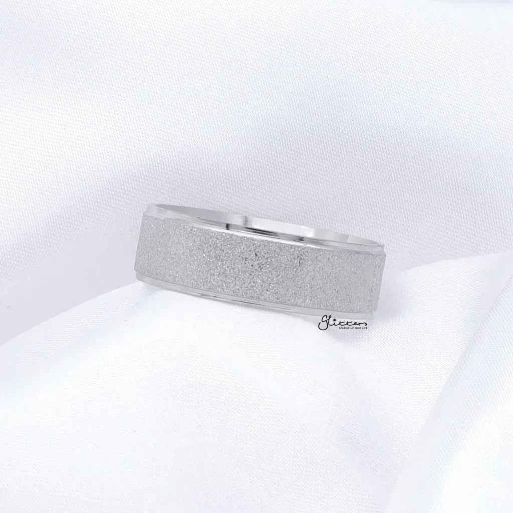 Stainless steel band ring with sandblasted finish, 8mm width, silver color, by Glitters, showcasing its textured surface and sleek design.