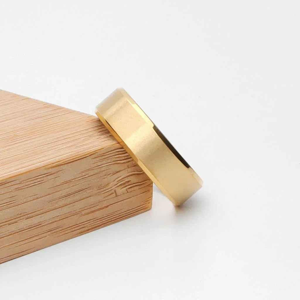 Glitters 18K gold ion-plated stainless steel ring with 8mm wide beveled edge band, stylish and durable jewelry accessory.