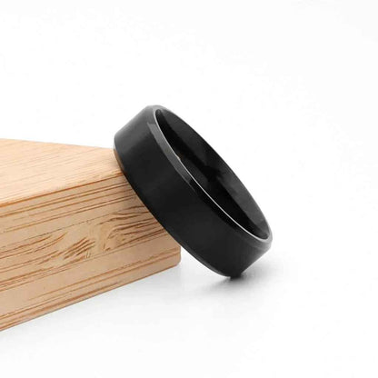 Black titanium ion-plated stainless steel 8mm wide beveled edge band ring from Glitters, showcasing sleek, modern design.