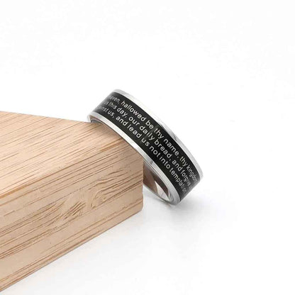 Glitters stainless steel Lord's Prayer spinner band ring with engraved text, smooth polished finish, and adjustable fit.