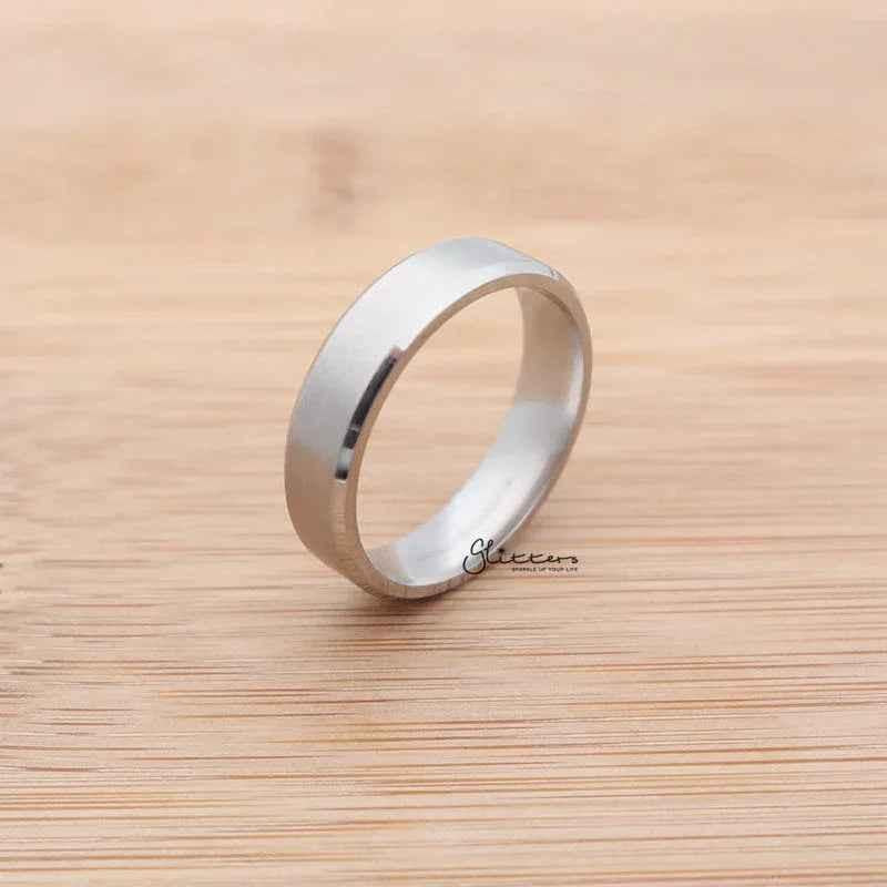 Silver stainless steel 6mm wide beveled edge band ring with a sleek, polished finish from Glitters.
