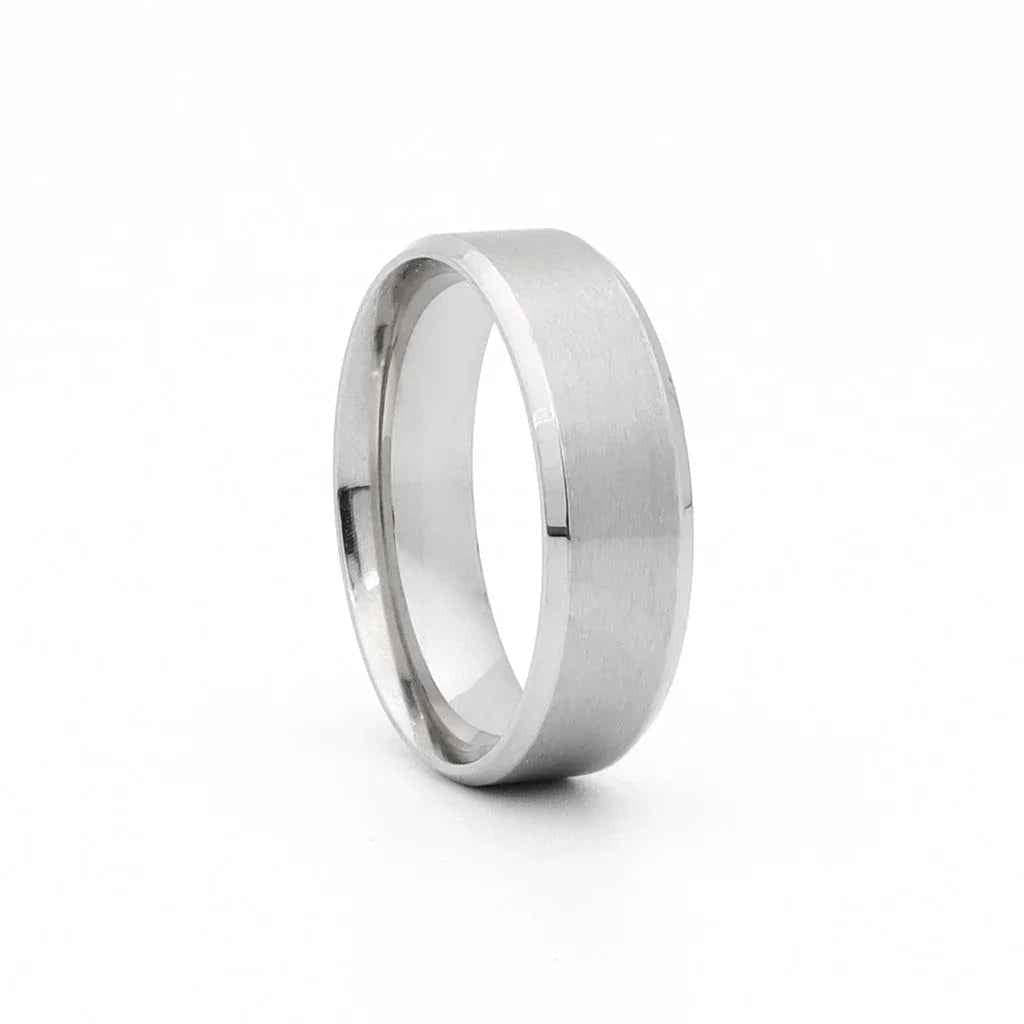 Stainless steel 8mm wide beveled edge band ring by Glitters, showcasing a sleek, polished design on a plain background.