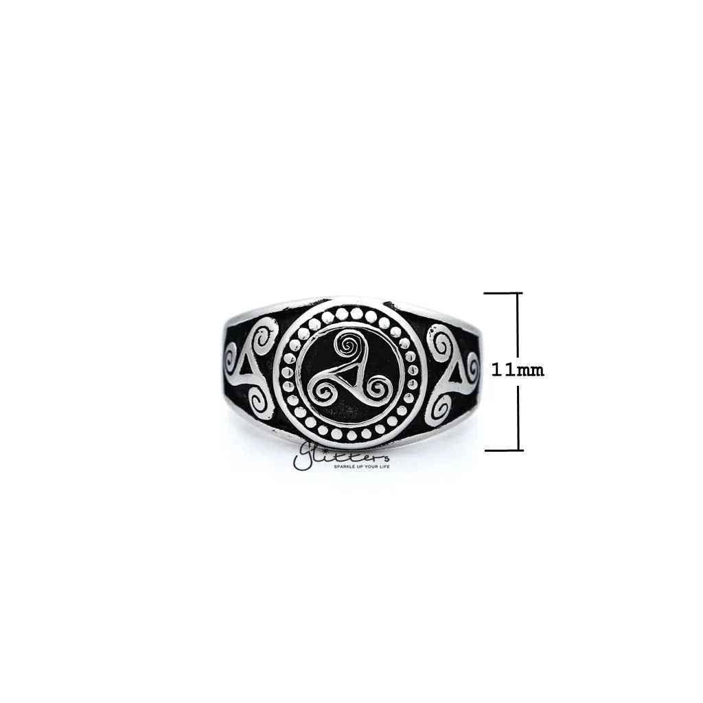 Stainless steel men's ring with antiqued triskele and triple spiral design, cast by Glitters, showcasing intricate metalwork and craftsmanship.