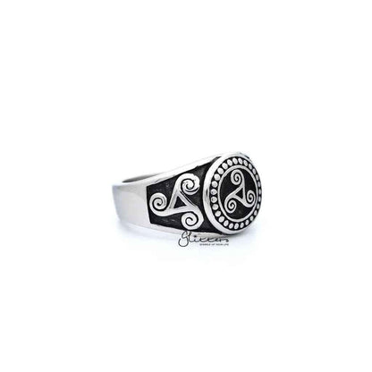 Stainless steel men's ring with antiqued triskele and triple spiral design, featuring detailed casting from Glitters.