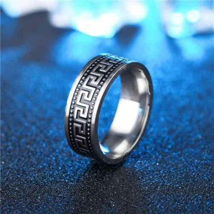 Stainless steel Greek key band ring by Glitters, 8mm wide, featuring a detailed Greek key pattern on a sleek silver-tone ring.