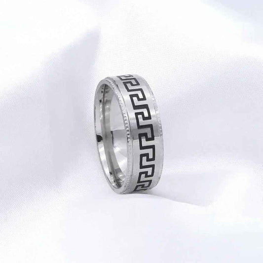 Silver stainless steel Greek key pattern band ring by Glitters, featuring intricate geometric design on smooth silver surface.