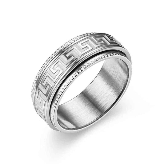 Stainless steel Greek key pattern spinner ring by Glitters featuring intricate engraved design on a sleek band.