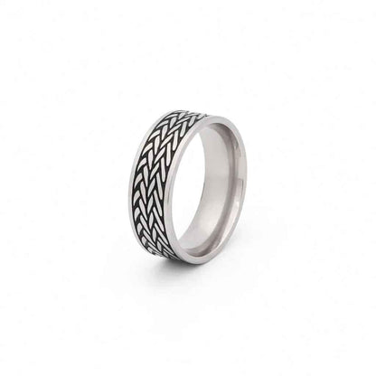Stainless steel leaf pattern band ring by Glitters featuring detailed engraved leaf design on a smooth band.