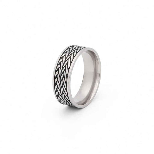Stainless steel leaf pattern band ring by Glitters featuring detailed engraved leaf design on a smooth band.