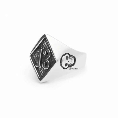 Stainless steel number 13 and skulls ring by Glitters featuring a bold design with engraved numbers and skull motifs.