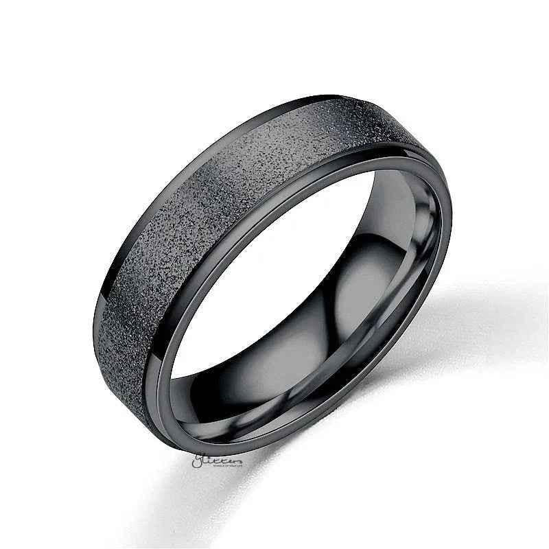 Black stainless steel band ring with a sandblasted finish, showcasing a sleek, matte texture from Glitters.