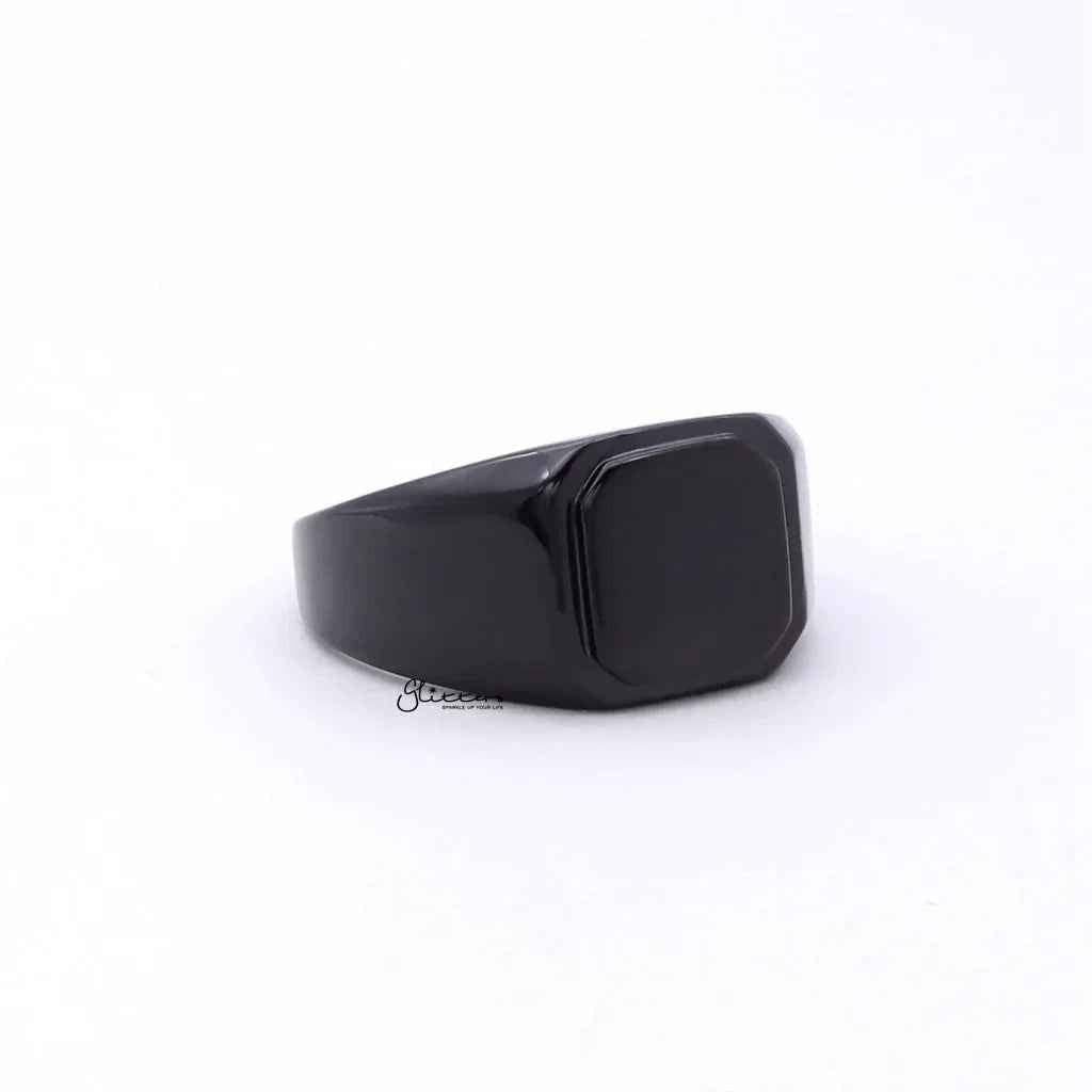 Black stainless steel square flat top signet ring by Glitters, showcasing a sleek, modern design with a polished finish.
