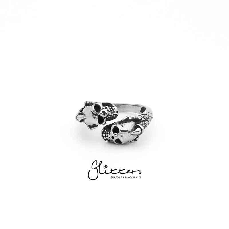 Stainless steel ring featuring two skull heads with a dragon claw design, by Glitters, showcasing detailed craftsmanship.