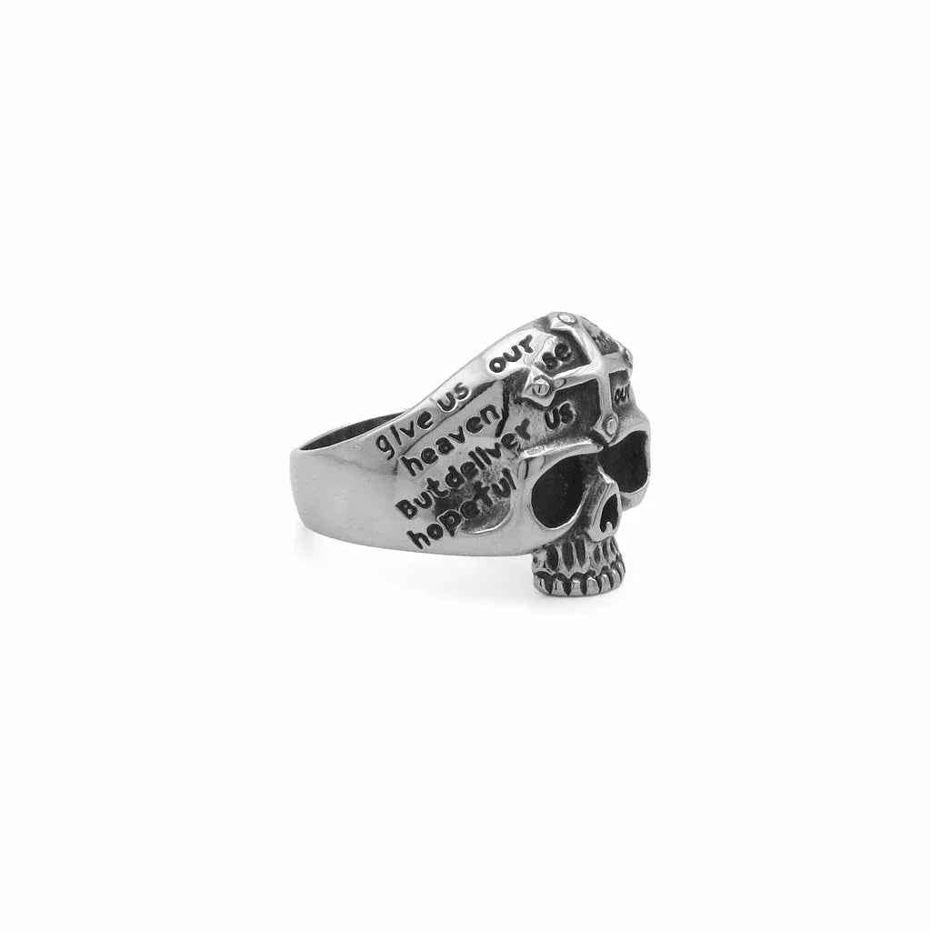 Stainless steel skull ring with cross and script engraving, featuring a detailed design, by Glitters.