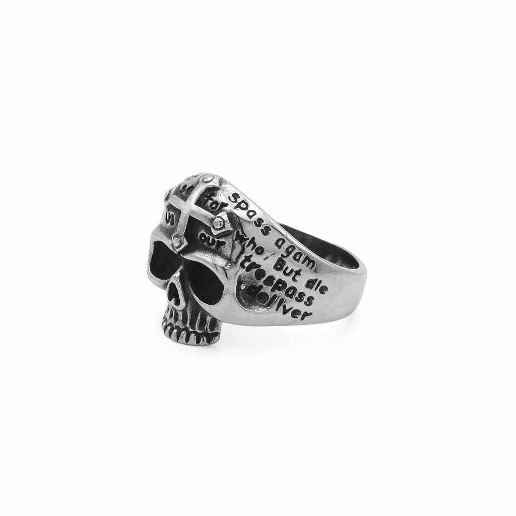 Stainless steel skull ring with cross and script engraving from Glitters, featuring detailed design on a sleek band.