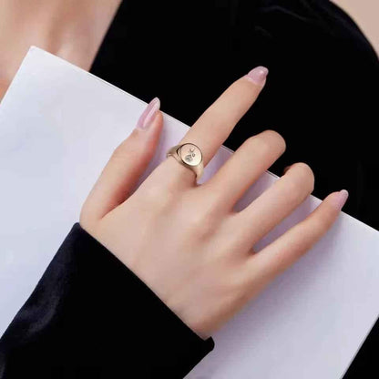 Personalised stainless steel round signet ring by Glitters, showcasing a sleek silver band with custom engraved design.