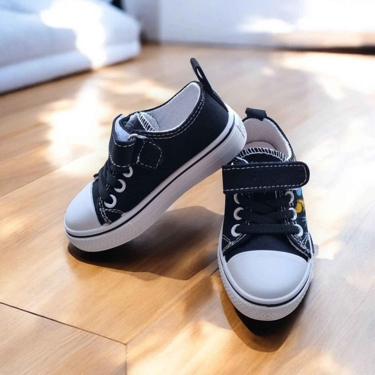 Colorful DinoTeam Canvas Sneakers by Happy Feet NZ, showcasing vibrant patterns and a comfortable fit for kids.