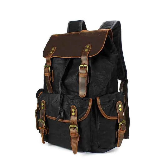 Black waxed canvas computer travel bag with leather accents, Mead's Supply & Equipment Outfitters laptop backpack for work and school.