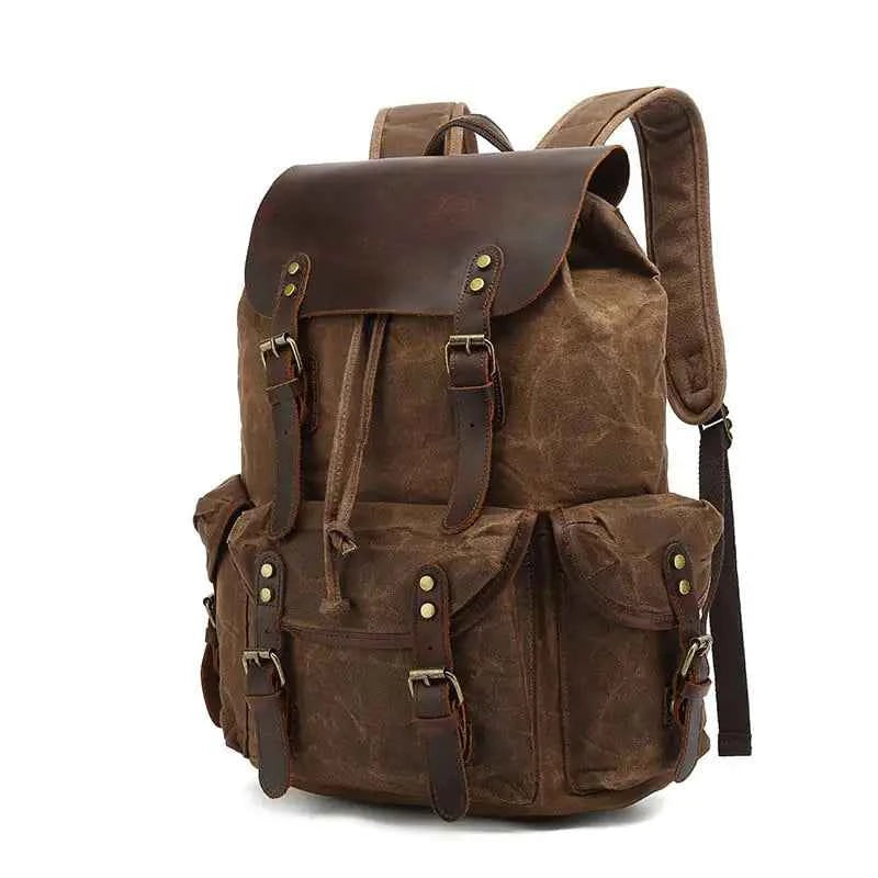 Black waxed canvas computer travel bag with leather accents, 20-35L laptop backpack for work and school by Mead's Supply.