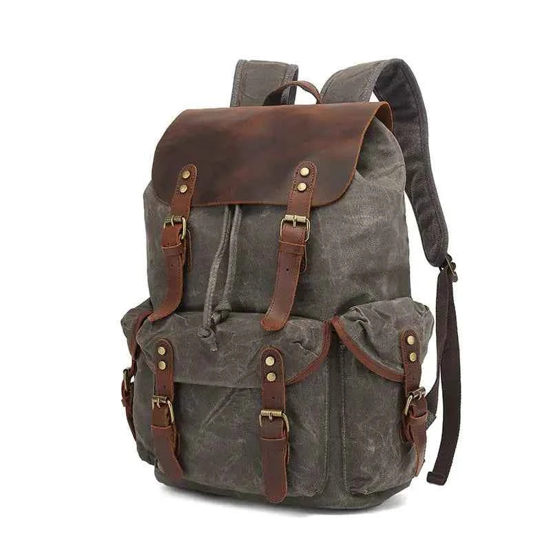 Black waxed canvas computer travel bag with leather accents, Mead's Supply & Equipment Outfitters 20-35L laptop backpack for work and school.