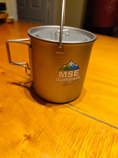 Titanium camping cookware 750ml pot by MSE Outfitters for ultralight camp cooking, shown with a lid and compact design