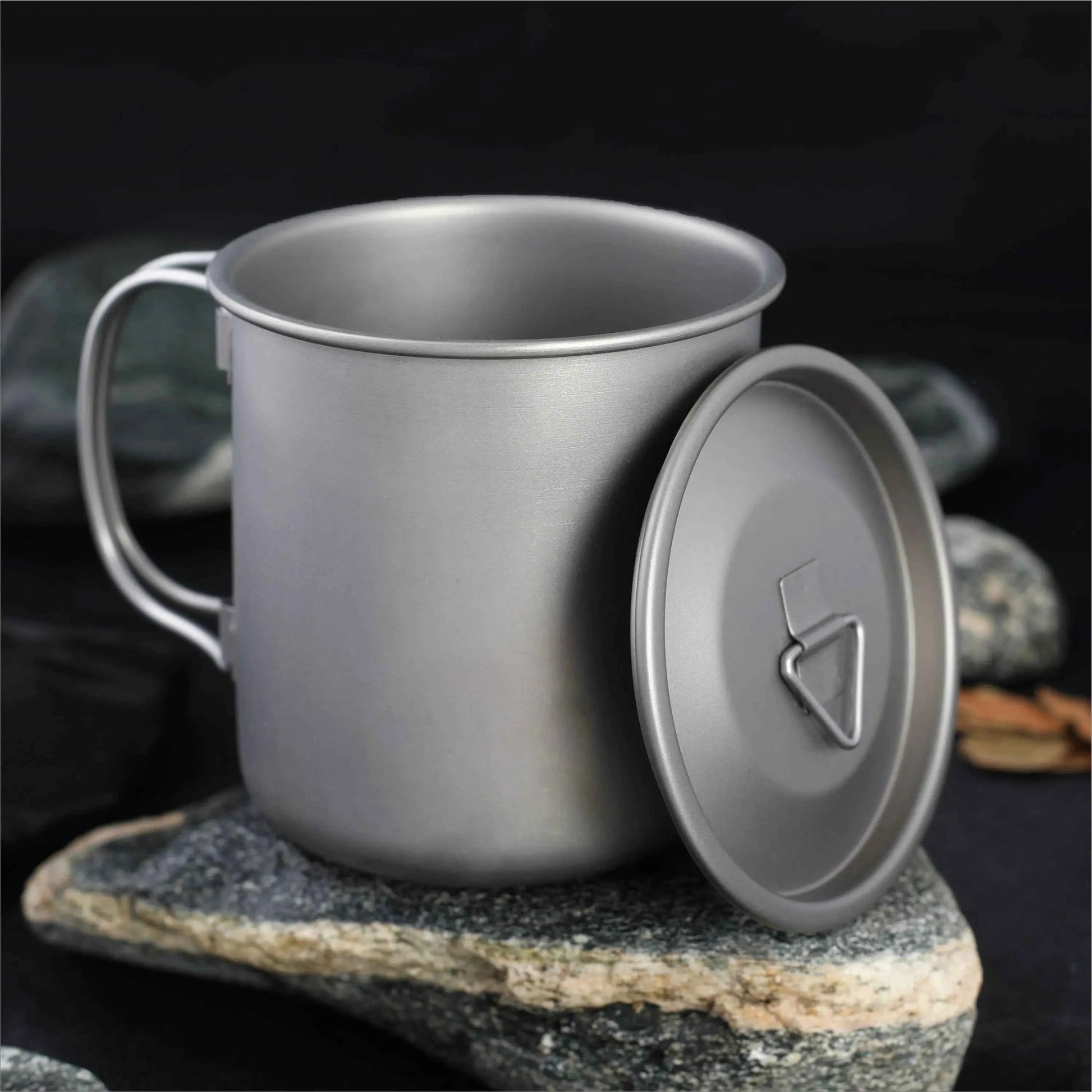 Titanium folding camping cup with lid, ultralight collapsible travel mug for outdoor camping and hiking by Mead's Supply.