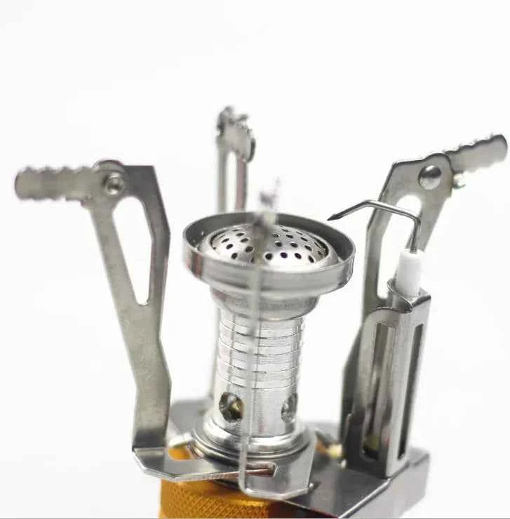 Portable mini camping stove by Mead's Supply, lightweight aluminum butane burner for outdoor cooking, suitable for 1-3 persons.