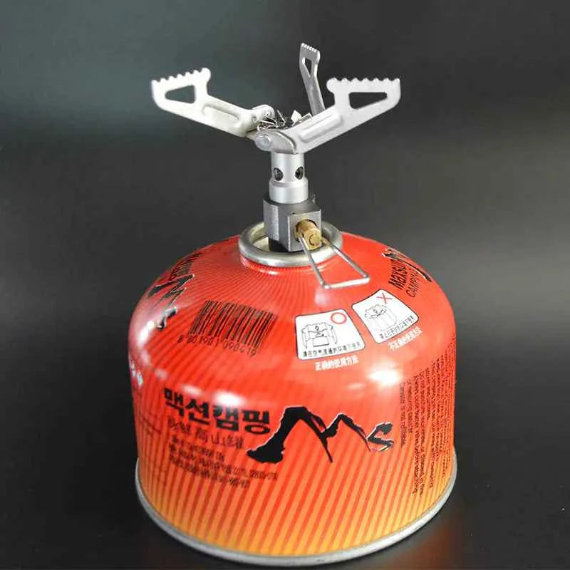 Portable titanium gas stove for camping and hiking by Mead's Supply & Equipment Outfitters, compact outdoor cooking gear.