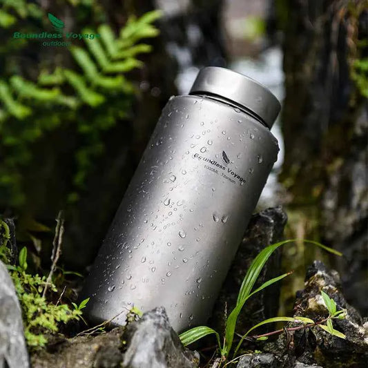 Silver titanium outdoor water bottle by Mead's Supply, 1000ml leak-proof camping flask, lightweight hiking drinkware.