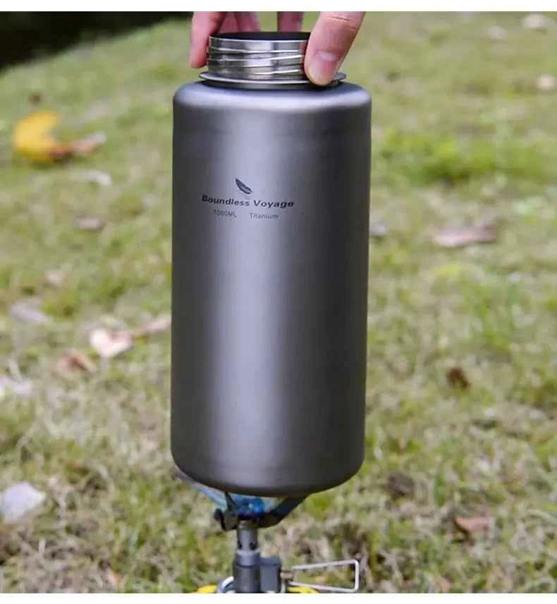 Silver titanium outdoor water bottle by Mead's Supply, 1000ml leak-proof camping flask for hiking and outdoor activities.