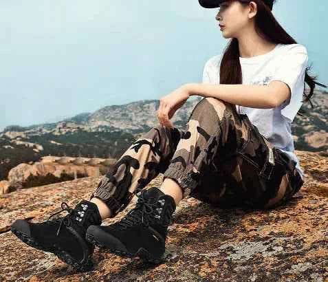 Black women's waterproof hiking boots by Mead's Supply & Equipment Outfitters, lightweight climbing shoes with sturdy tread and ankle support.