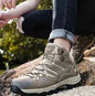 Mead's Supply & Equipment Waterproof WOLFF high-top trekking shoes with enhanced grip for hiking, black footwear with rugged sole.