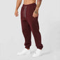 Men's black athletic track sweatpants with side stripe from Mead's Supply & Equipment Outfitters, designed for comfort and active wear.