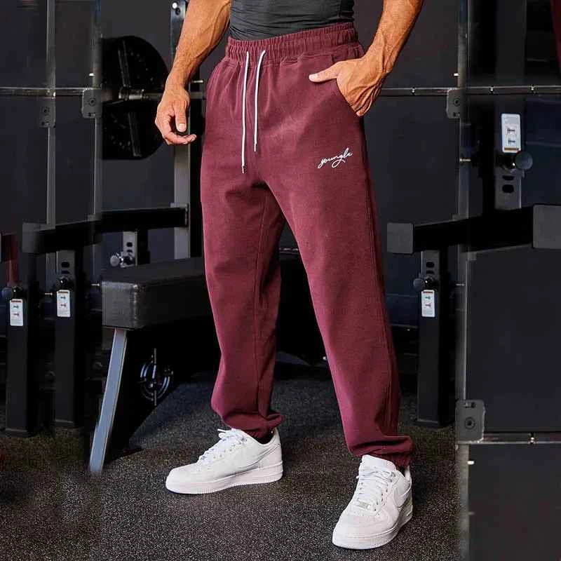 Men's black athletic track sweatpants with side stripe, sporty joggers by Mead's Supply & Equipment Outfitters.