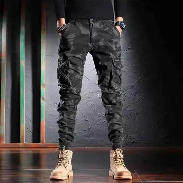 Men's oversized camouflage cargo pants by Mead's Supply & Equipment Outfitters, with multiple pockets, khaki outdoor trousers.