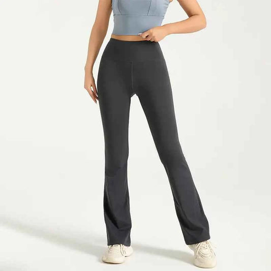 Gray high waist flared yoga pants with hip-lifting design, bell bottom style, part of women's athletic wear by Mead's Supply & Equipment.