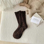 Thick diamond-shaped wool mid-thigh socks for women, warm cozy leg warmers ideal for fall and winter warmth.