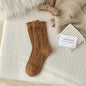 Thick diamond-shaped wool mid-thigh socks for women, warm cozy leg warmers suitable for fall and winter by Mead's Supply & Equipment.