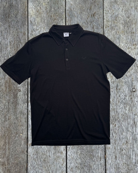 Men's black polo shirt made from 100% Merino Wool by Merino 365 NZ, showing a classic polo collar and soft fabric.