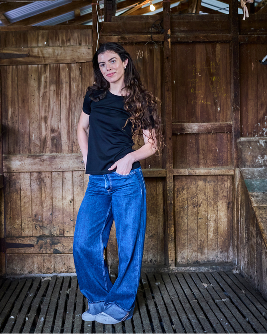 Black women's crew T-shirt made from 100% Merino Wool by Merino 365 NZ, shown flat with neckline and short sleeves visible.