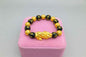 Stylish 3Sixty5 gold bracelet with black beads, featuring a sleek and elegant design for everyday wear.