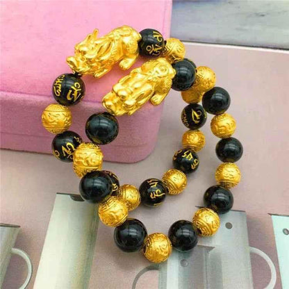 Stylish 3Sixty5 gold bracelet with black beads, featuring a sleek and elegant design for fashionable accessory wear.