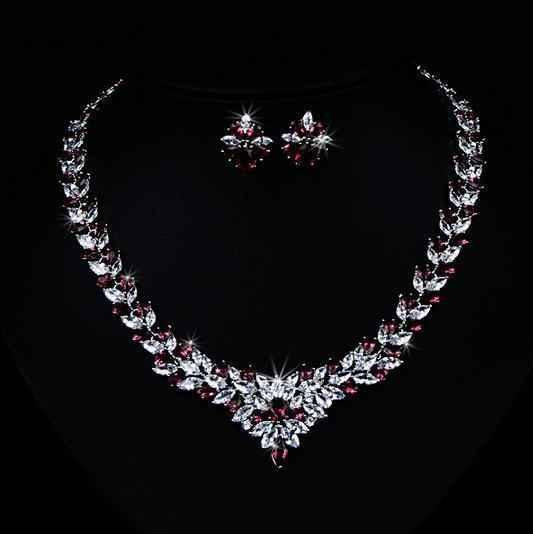 Stylish 3Sixty5 floral radiance zircon jewelry set featuring a necklace and earrings with red floral design and sparkling stones.