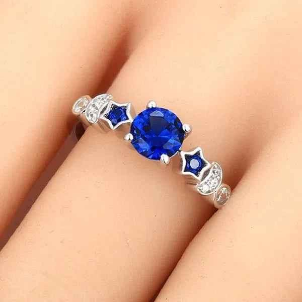 Women's blue gemstone moon ring by Stylish 3Sixty5, featuring a sleek silver band and a vibrant blue gemstone moon design.