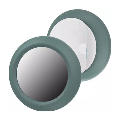Black and green holder for Apple Air Tag, designed by That Watch Shop, shown attached to a keychain or item for tracking.