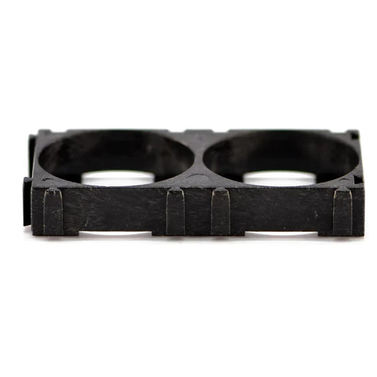 Two 26650 spacer batteries for watch power supply from That Watch Shop, shown with clear focus on the batteries and spacer.