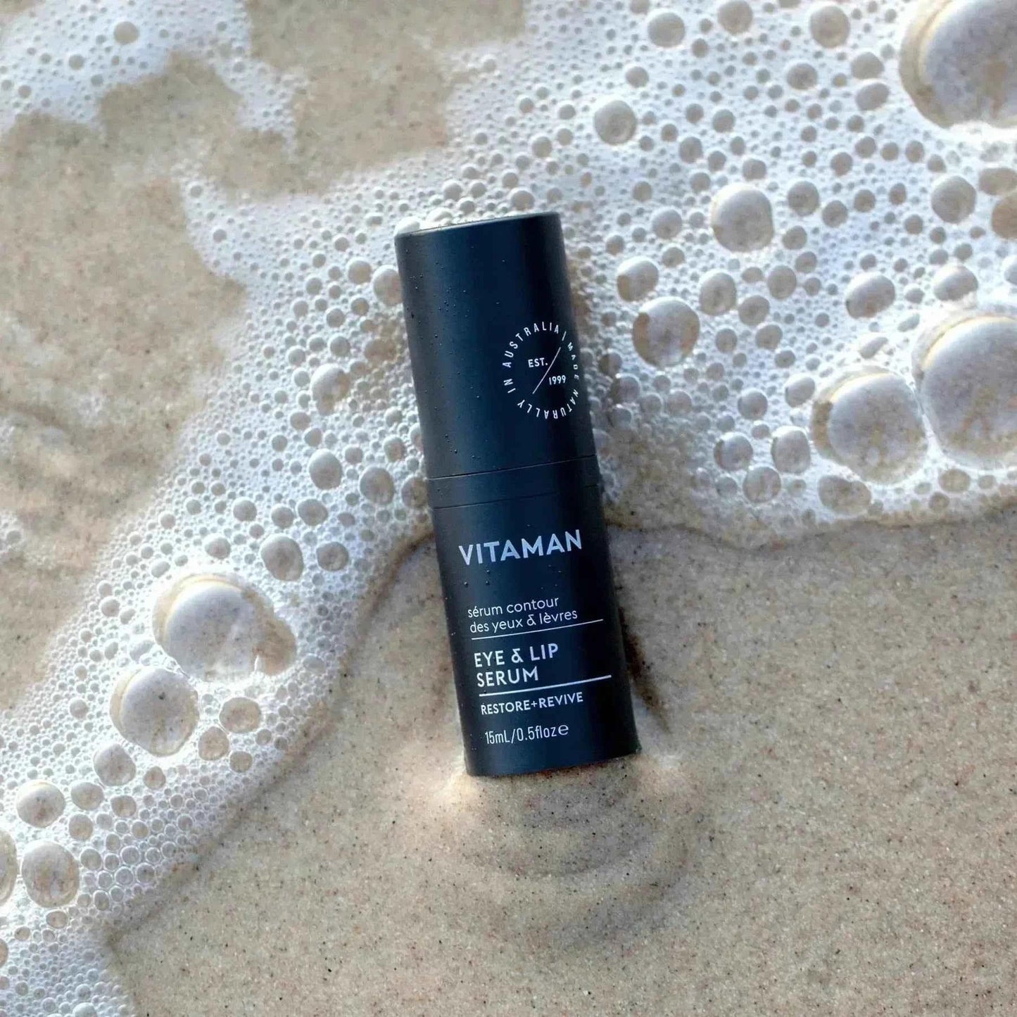 VITAMAN Australia Eye & Lip Serum for face showing the serum applicator and container, designed to reduce puffiness and fine lines.