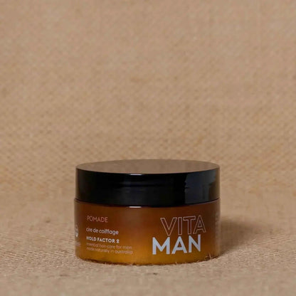 VITAMAN Australia hair pomade 100g jar with black lid, smooth texture for styling hair, shown on a white background.