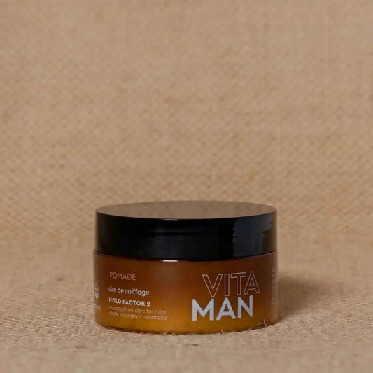 VITAMAN Australia hair pomade 100g jar with black lid, smooth texture for styling hair, shown on a white background.